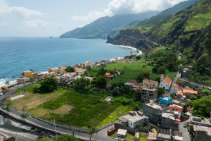 Small town at rough rocky beach coastline of green cape verde island